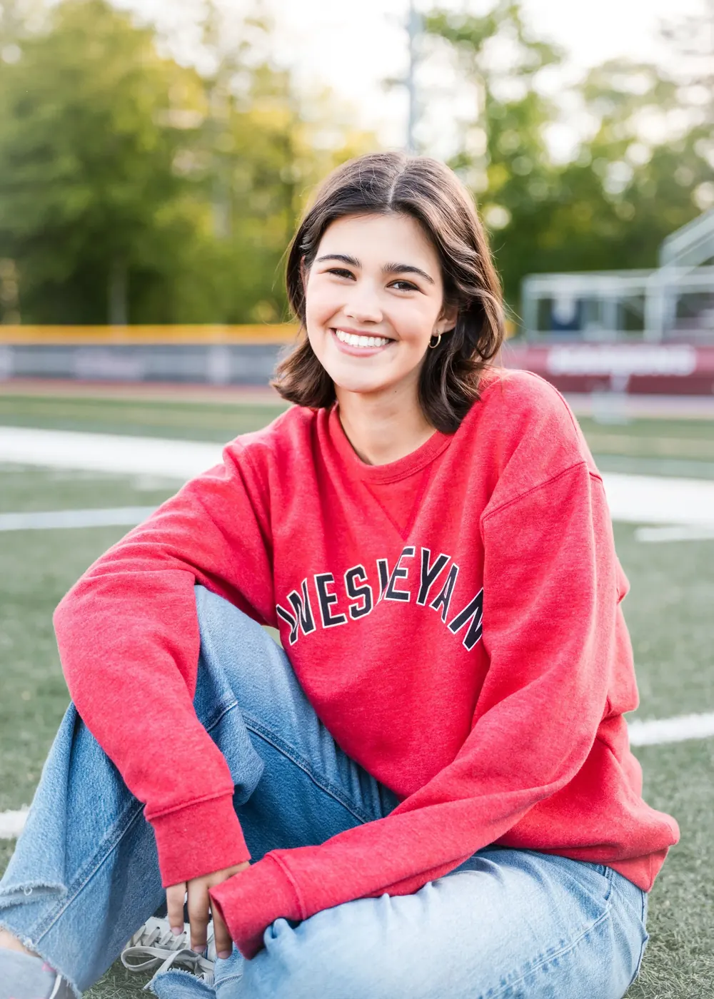 Julia Lebow wearing a red Wesleyan sweatshirt outdoors.